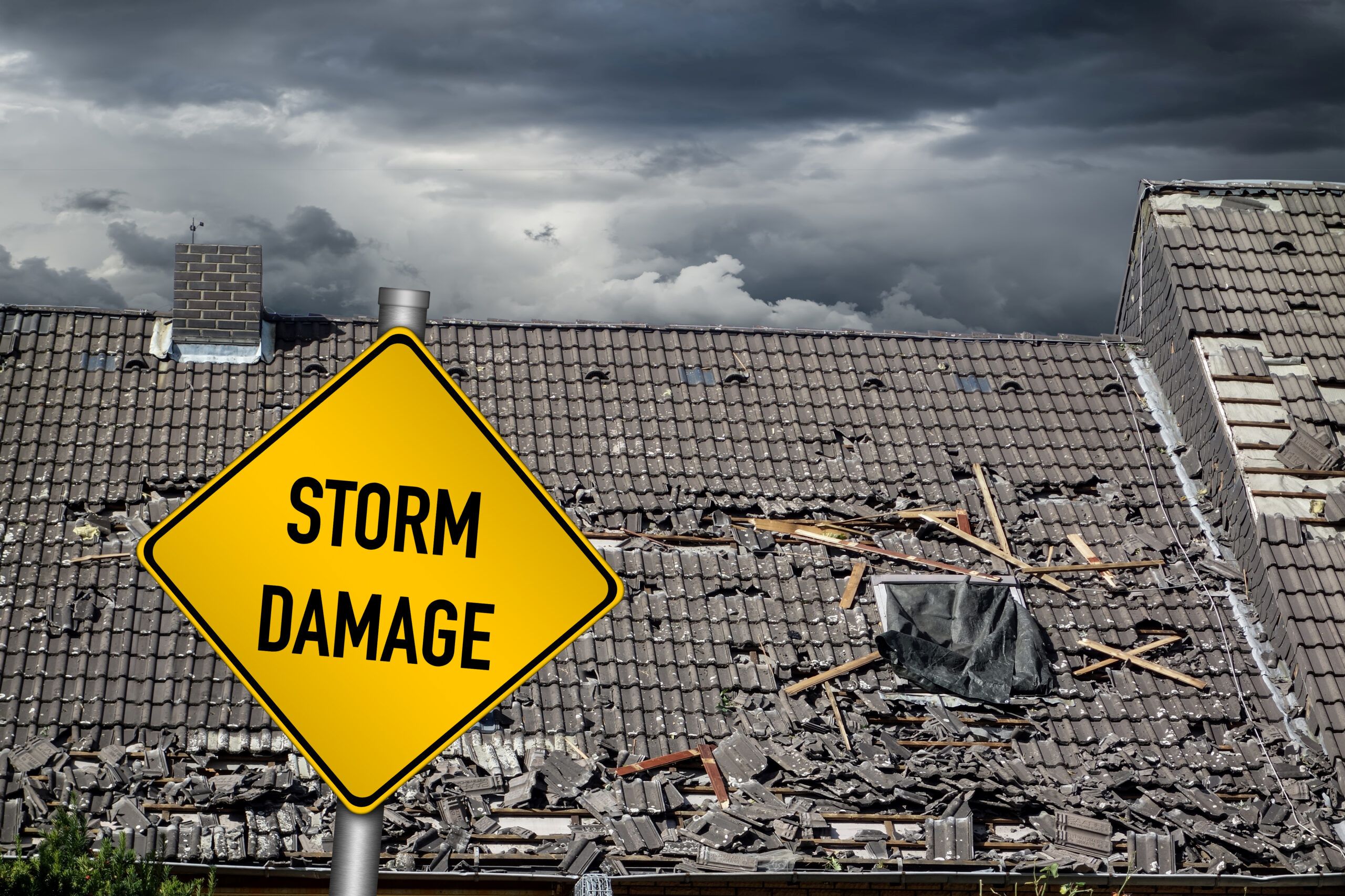 Severe storm damage on a residential roof with a caution sign highlighting the importance of storm preparedness and preventative measures.